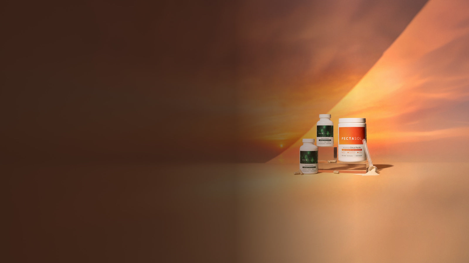 ecoNugenics GlyphoDetox and PectaSol powder against a summer sunset sky