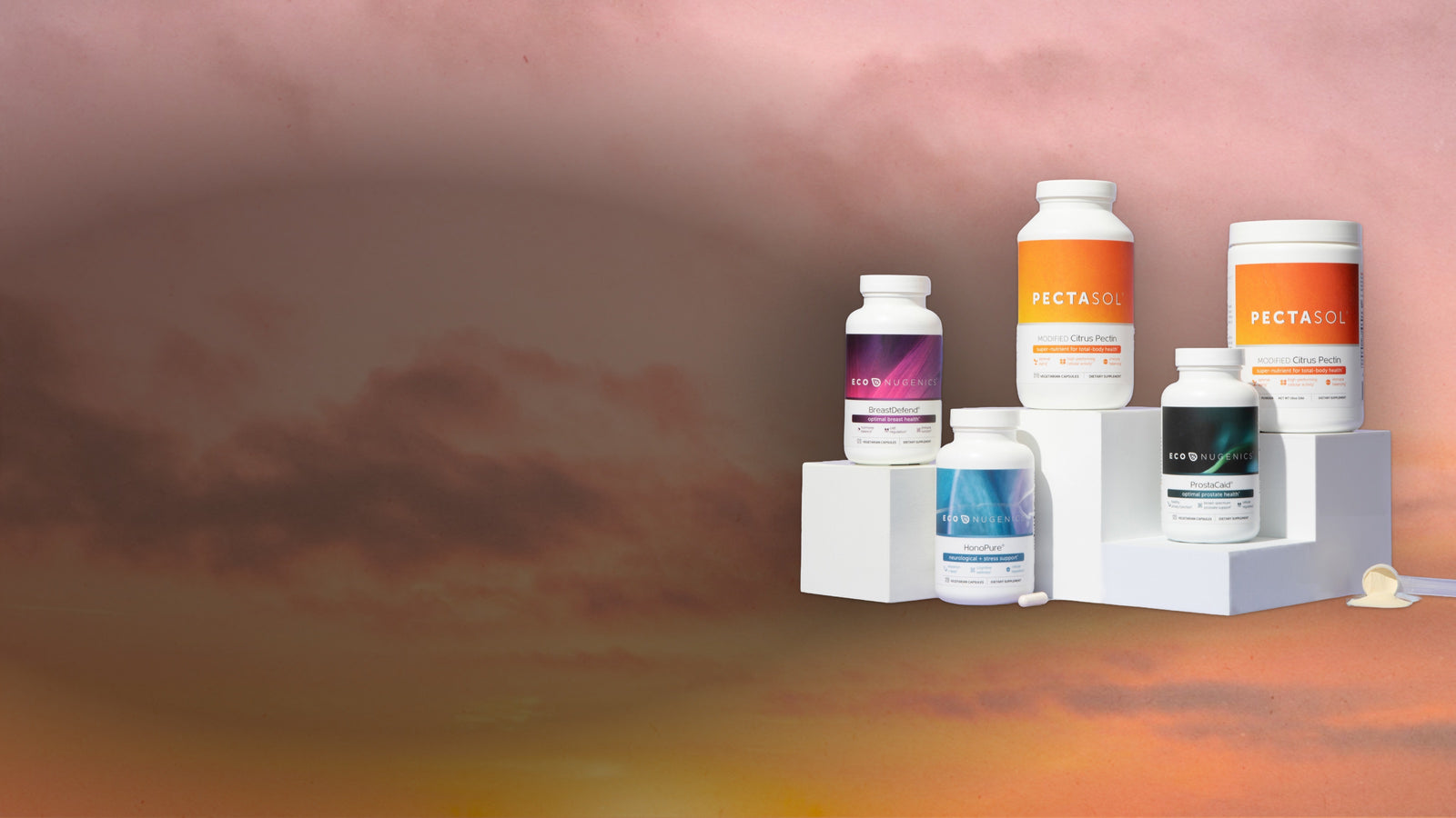 Assorted ecoNugenics supplement bottles against a summer sunset sky