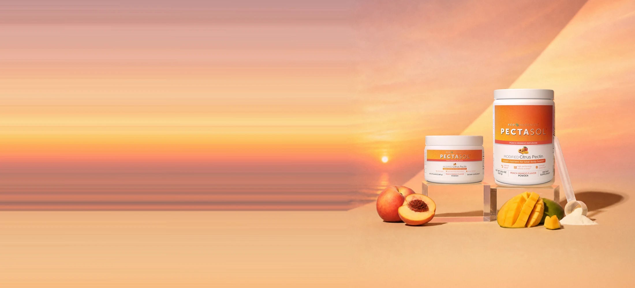 Glass of peach mango PectaSol infusion on a sunny table with fruit